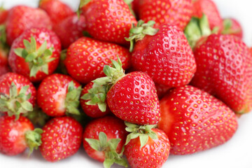 Fresh red strawberries with leaves. Pile of ripe strawberry for background