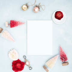Cute modern holiday flat lay with brush tree and Christmas ornaments and blank stationery card