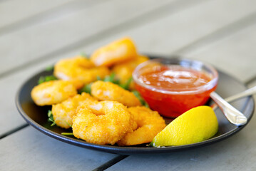 Grilled tiger shrimps with spice and lemon in bar outside. seafood