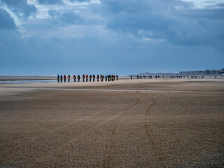 Group of bike racers on French - Belgium Border, beach endurance