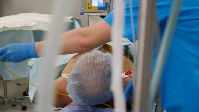 Reanimation and medicine. Life saving. Male patient in surgery. Cardiographic machine electrodes on male chest during medical intervention. recording electrical cardiogram. 4 k video