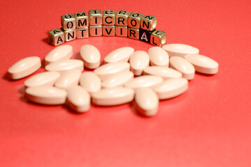 Omicron antiviral tablets. Antiviral drugs. Inscription omicron from letters