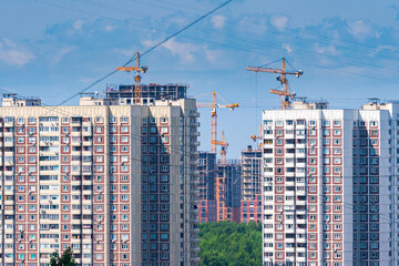 New buildings in the south-west of Moscow. Various stages of construction. Cranes in an urban environment