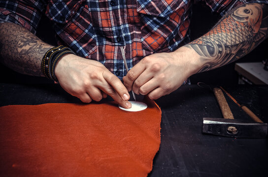 Worker of leather producing leather goods