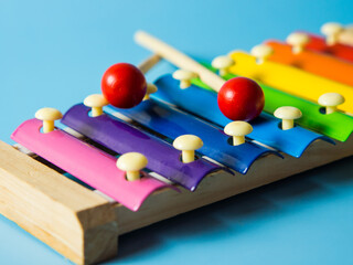 colorful educational xylophone toy on a blue background with copy space. Children's toy and musical...