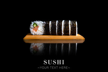 Japanese Maki sushi roll with salmon and cucumber. Served on wooden board. Asian dish on black...