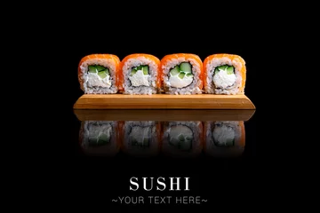 Foto op Plexiglas Salmon Japanese sushi inside out roll with cucumber, cream cheese. Served on wooden board. Asian dish on black background with reflection. Banner with Text space   © Art Food