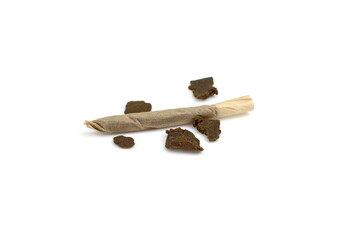 Home made hashish from cannabis isolated on white background. Medical marijuana moroccan hash cannabis pollen hashish closeup joint.