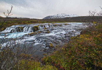 Picturesque waterfall Bruarfoss autumn view. Season changing in southern Highlands of Iceland.