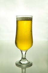 illuminated beer glass on white background