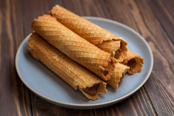 Wafer rolls with condensed milk. Thin and Crispy Waffle. Selective focus