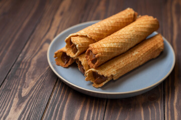Wafer rolls with condensed milk. Thin and Crispy Waffle. Selective focus