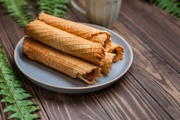 Wafer rolls with condensed milk. Thin and Crispy Waffle. Selective focus