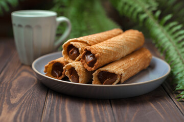 Fototapeta na wymiar Wafer rolls with condensed milk. Thin and Crispy Waffle. Selective focus