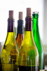 choose a wine, bottle of open wine half empty after a party