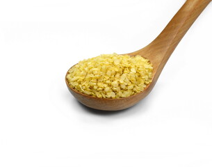Millet flakes in a wooden spoon isolated on white bacground.