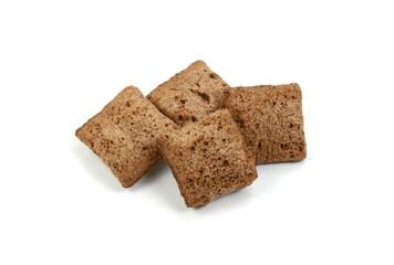 Heap of chocolate pillow cereals isolated on white background. Nougat filled chocolate pillow wafers pile isolated on white background. Crispy chocolate cereal pillow flakes.