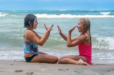 Two sisters are Playing games on the beach
