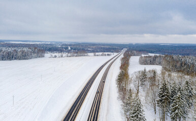 Obraz premium Aerial bird-eye view on freeway road in the winter field