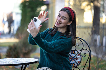 Happy young woman taking a selfie, preparing for the holiday of Christmas.