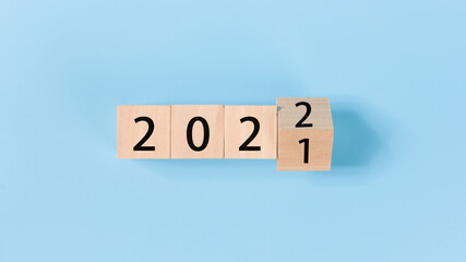 woodblocks cubes with a number 2021 change to 2022 blue background. 