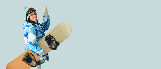 Female snowboarder on light background with space for text