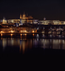 Fototapeta premium night view of prague castle and st. vitus and cathedral bridge on ece vltava at night in the center of prague