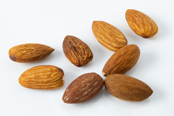 Dry and roasted almonds, still with skin and salted, ready for consumption, isolated on white background