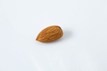 Roasted whole almond, ready to eat, isolated on white background.
