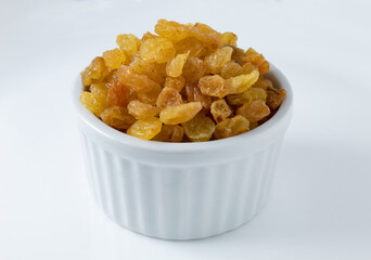 Dried white or sultana raisins in a white ceramic pot
