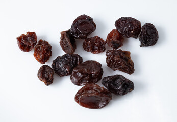 Small portion of dried, dark raisins isolated on white background