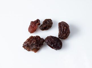 Dark dried raisins isolated on white background