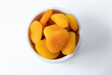Top view of dried and seedless Turkish apricots in ceramic ramekin