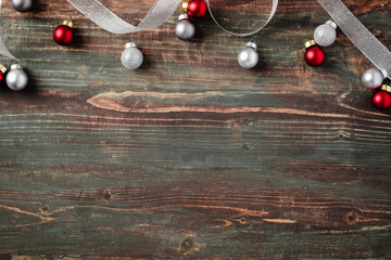 Christmas red bauble, white ribbon decoration on table wood background