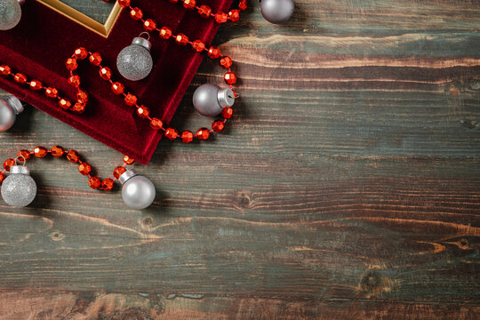 Christmas decoration ornament tiensel,ball and red frame n table wood background