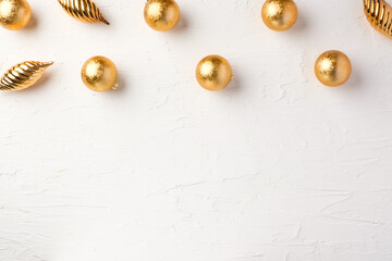 Christmas gold bauble ball decoration on white pastel table background
