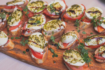 Catering table buffet dinner, beautifully decorated banquet with variety of different food snacks and appetizers on corporate birthday party event or wedding reception, canape, delicatessen setting