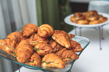 Set of coffee break in the hotel during conference meeting, with tea and coffee catering, decorated catering banquet table with variety of different pastry and bakery, with croissants and cookies