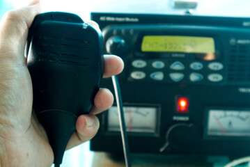 Hand holding speakerphone for contact.Radio communication concept.