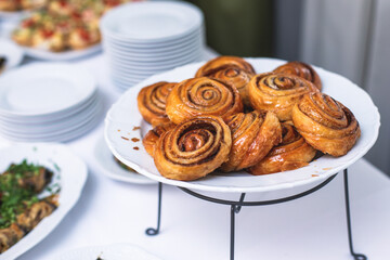 Set of coffee break in the hotel during conference meeting, with tea and coffee catering, decorated catering banquet table with variety of different pastry and bakery, with croissants and cookies