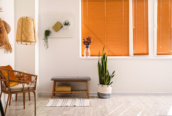 Interior of light room with modern bench and armchair