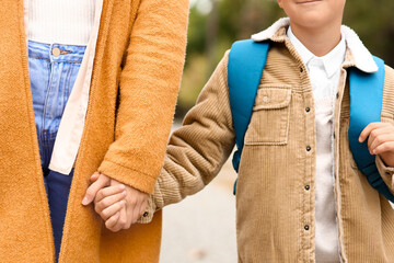 Woman walking her little son to school