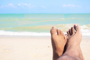 close-up foot vacation relax on the beach sunbathe enjoying the sun on a sunny summer day