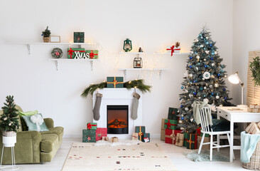 Interior of festive living room with modern workplace, Christmas trees and fireplace