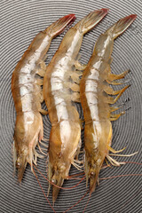 Raw shrimps are cooked on fry pan