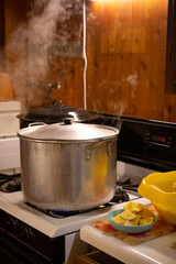 Large Silver Pot with Steam on Gas Stove in Cabin