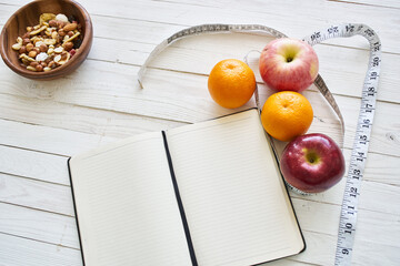 notepad on table measuring tape fruit breakfast nutritional fitness