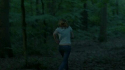 Scared woman running through forest