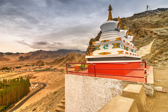 Thiksay monastery with view of Himalayan mountians and cloudy sky with white clouds in background,Ladakh,Jammu and Kashmir, India
