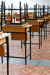 Desk and chairs in classroom at school 